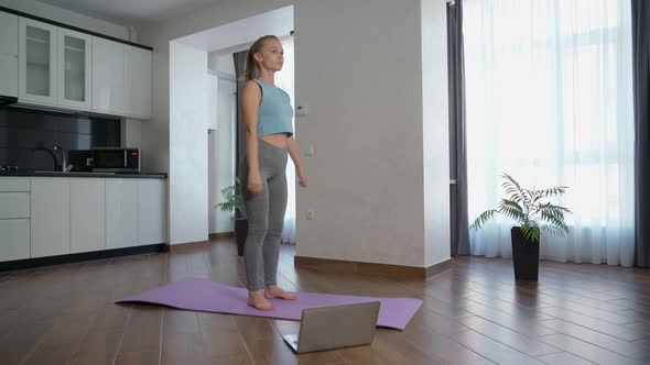 Fitness Woman Using Laptop While Exercising Home