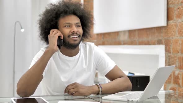 African Man Talking on Phone Discussing