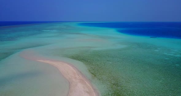 Wide aerial abstract view of a white sandy paradise beach and blue sea background in vibrant 4K