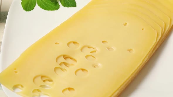 Delicious traditional Dutch farmers cheese with holes made by air bubbles close up for lunch  