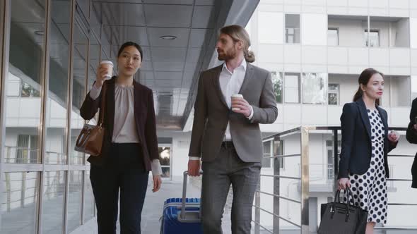 Businessman Carry Luggage for Business Trip Talking to Colleague