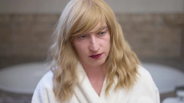 Upset Caucasian Transgender Woman Looking at Camera with Sad Facial Expression Sighing