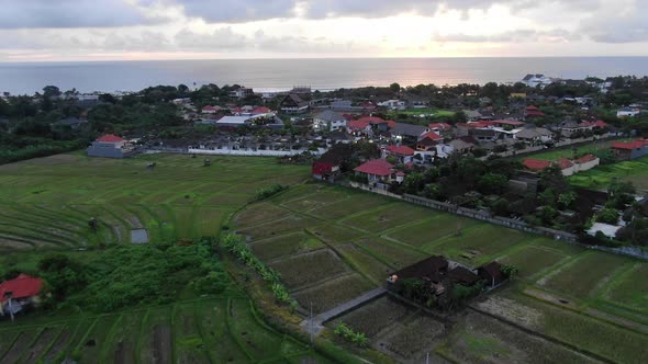 Aerial View over Bali Rice Fields Flying Towards the Ocean at Sunset