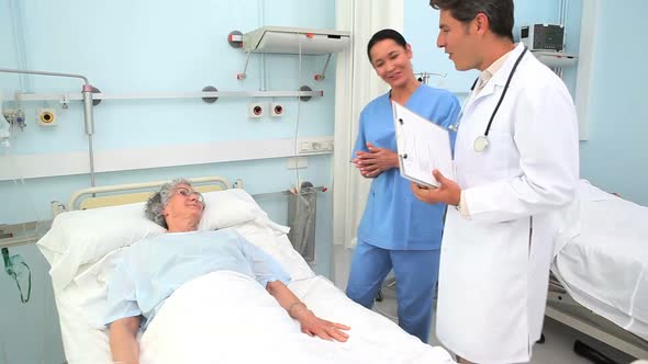 Doctor and nurse talking to a patient