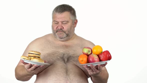 Obese Man Choosing Between Sandwich and Fruits