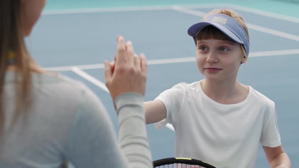 Tennis Coach And Little Girl Giving High Five