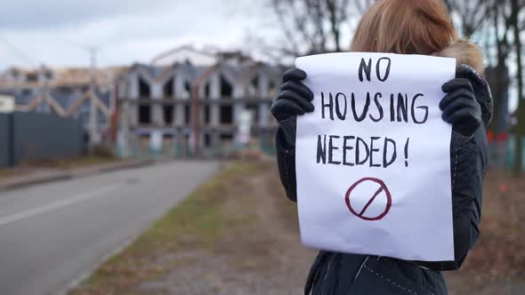 Female Activist with No Housing Needed Banner on the Right Mockup