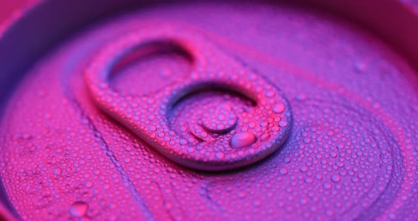 Beer can with water droplet with purple light