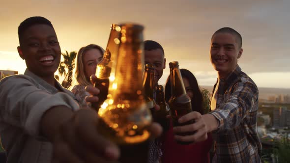 Group of friends drinking a beer on a rooftop