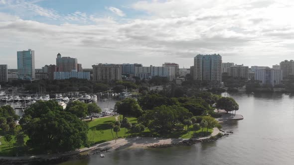 Beautiful downtown Sarasota, Florida as seen from a drone.  Lush green waterfront park and harbor ar