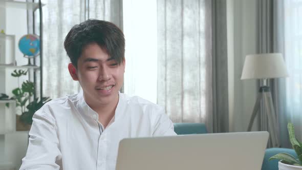 Close Up Of Asian Man Student Having Video Call While Using Computer To Study Online At Home