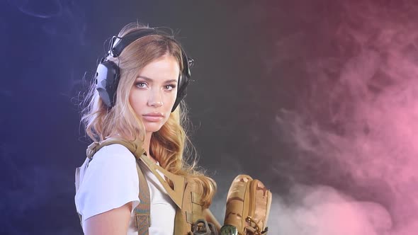 Heavily Armed Female Soldier in Battle Helmet Holding Assault Rifle