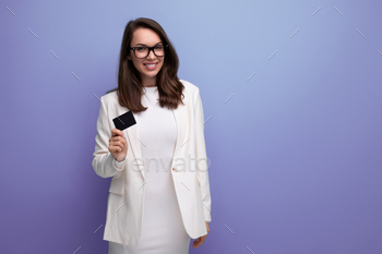 portrait of successful young business woman proudly standing with money card with salary