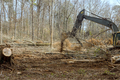 Using an excavator worker is clearing ground to build a house. - PhotoDune Item for Sale