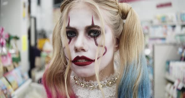 Female Model Dressed As Harley Quinn Smiling at Camera