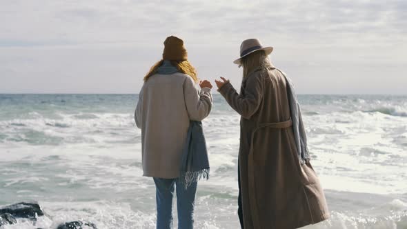 Beautiful Girls Walk Near the Sea