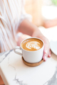 Woman hand holding coffee cup in coffee shop. - PhotoDune Item for Sale