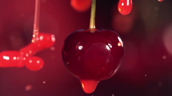 Cherries in Juice Splash Dark Red Background in Slow Motion