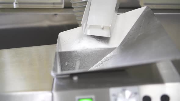 White Pills on Conveyor Line in Interior of Modern Pharmaceutical Company