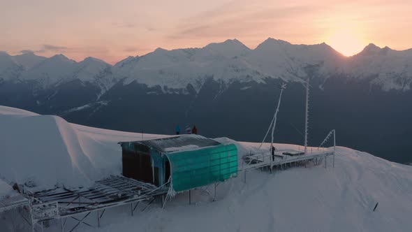 Meteostation and Tourists Team on Snowy Slope of Aibga Ridge