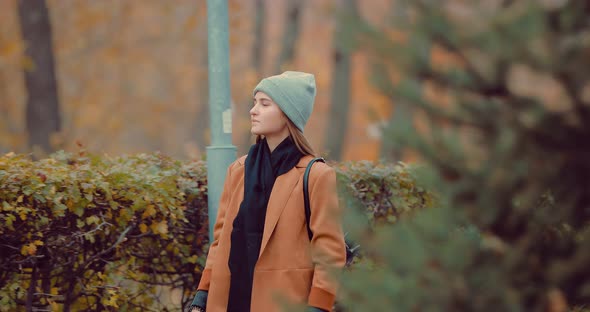 Beautiful Girl Walking in the Autumn Park