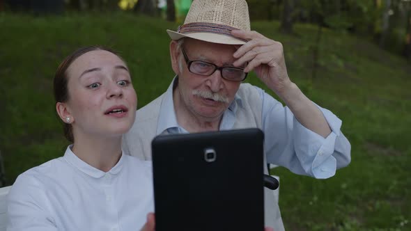 Old Man and Young Nurse Chat on Tablet