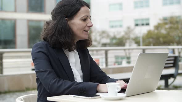 Businesswoman Having Video Chat in Cafe