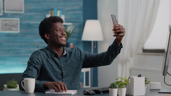Authentic Happy African American Man Taking a Selfie in the Living Room to Share It on Social Media