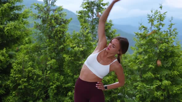 Fit Woman Warming Up with Lateral Body Bends