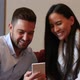 A young couple discussing content on a smartphone - VideoHive Item for Sale