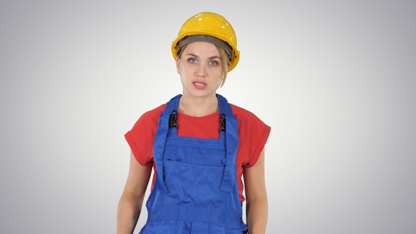 Woman in construction outfit talking to camera while walking