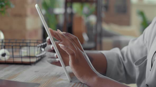 Unrecognizable Black Woman Using Tablet