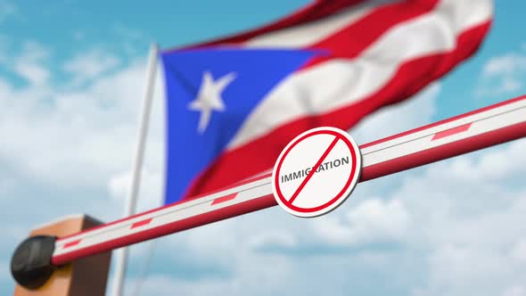 Opening Barrier with Stop Immigration Sign at Puerto Rican Flag