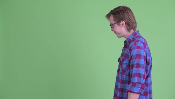 Profile View of Stressed Young Hipster Man with Face Palm Gesture