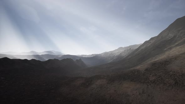 Sun Rays Over Mountains in a Valley