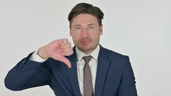 Middle Aged Businessman showing Thumbs Down Gesture, White Background