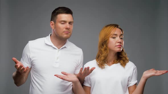 Confused Couple in White T-shirts Shrugging