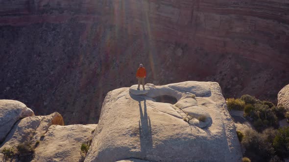 Aerial shot of a hiker at the the edge of Cedar Mesa in Utah