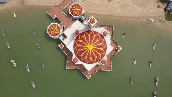 Aerial ascending top down view floating mosque