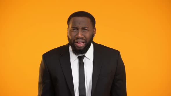 Frustrated Afro-American Man in Business Suit Making Facepalm, Shocked With News