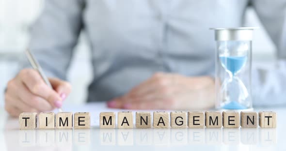 The Inscription Time Management on Wooden Cubes on Table