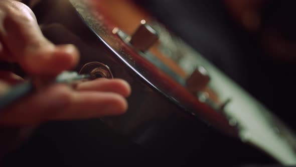 Man Hand Connecting Guitar in Concert Hall. Sound Engineer Preparing Instrument.