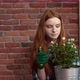 Beautiful Redhead Girl Looking After Flowers - VideoHive Item for Sale