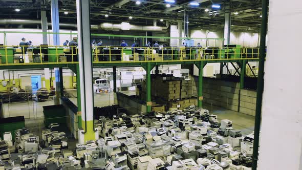 Dumpsite Premises with Discarded Office Machines and Workers