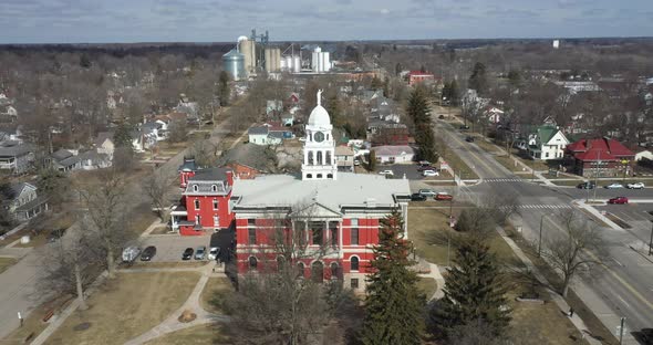 Historic Eaton County courthouse in Charlotte, Michigan with drone flying over with skyline.