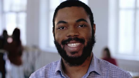 Close-up Portrait of Happy Positive Smiling African Manager Businessman with Beard at Modern Office