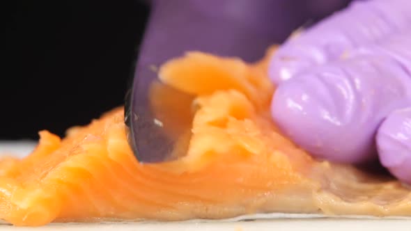 Sushi Chef Cuts a Slice of Trout. Close Up