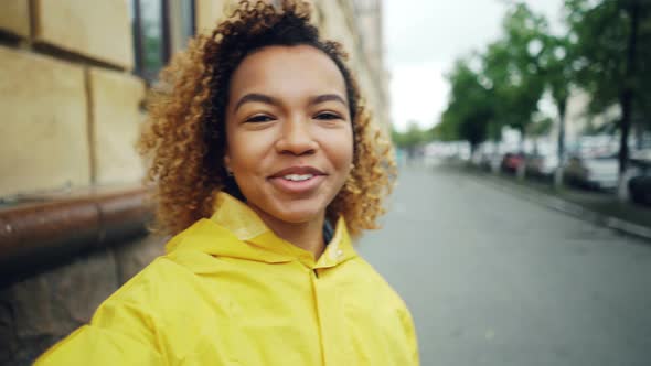 Point of View Shot of Cheerful Young Woman Blogger Looking at Camera, Talking and Waving Hand