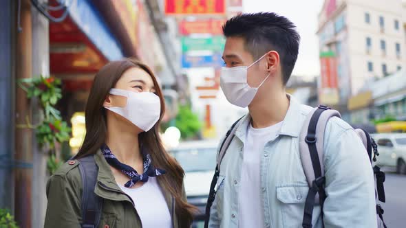 Asian romantic couple wear mask, travel in the city for honeymoon trip.