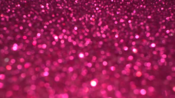 Shiny magenta surface rotates. Magic bokeh background